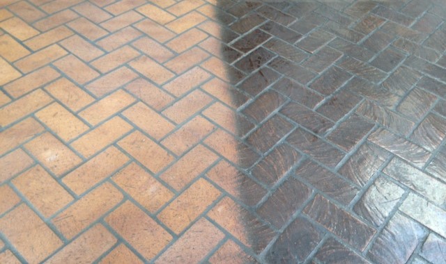 b5af40ab-48a0-4311-9af9-67b607aa8da8Media Blasting Add to middle of page 1. Herringbone Before & After A brick floor with a herringbone pattern and a tile floor.